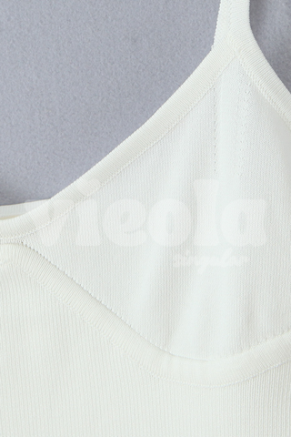 Close-up of a light gray tank top on a gray background